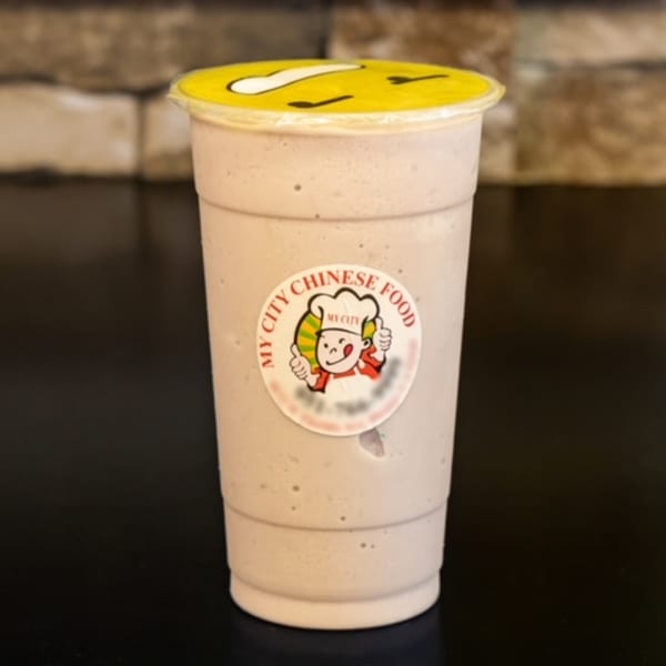 My City Chinese Food branded bubble tea with a yellow lid on a dark surface.