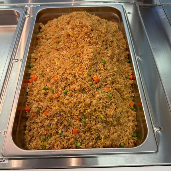 A large metal tray filled with My City Chinese Foods' fried rice, featuring peas and carrots.