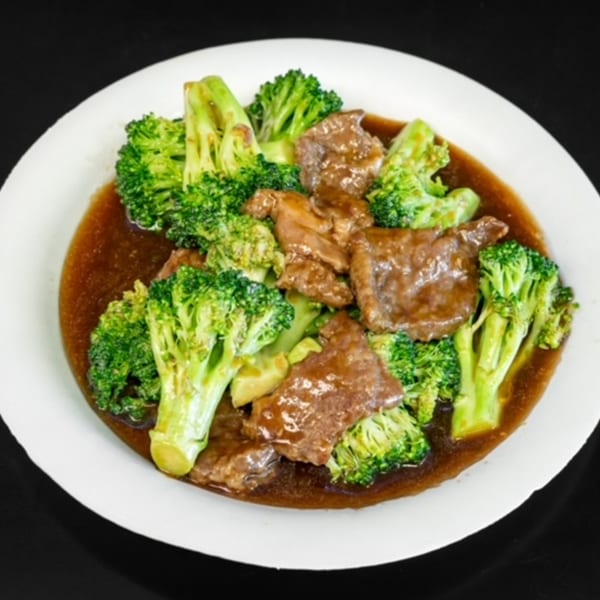 Beef and broccoli in a savory brown sauce, served on a white plate from My City Chinese Foods.