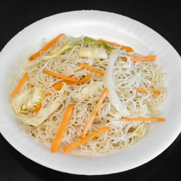 A white plate of My City Chinese Foods' pancit bihon with noodles, carrots, and cabbage.