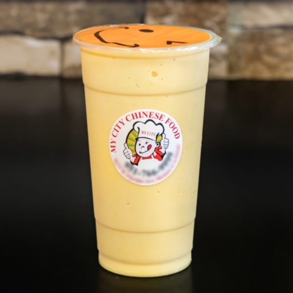 A yellow My City Chinese Food smoothie with a smiley face lid sits on a dark surface.