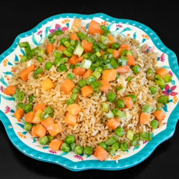 My City Chinese Foods' fried rice with peas, carrots, and green onions on a decorative plate.