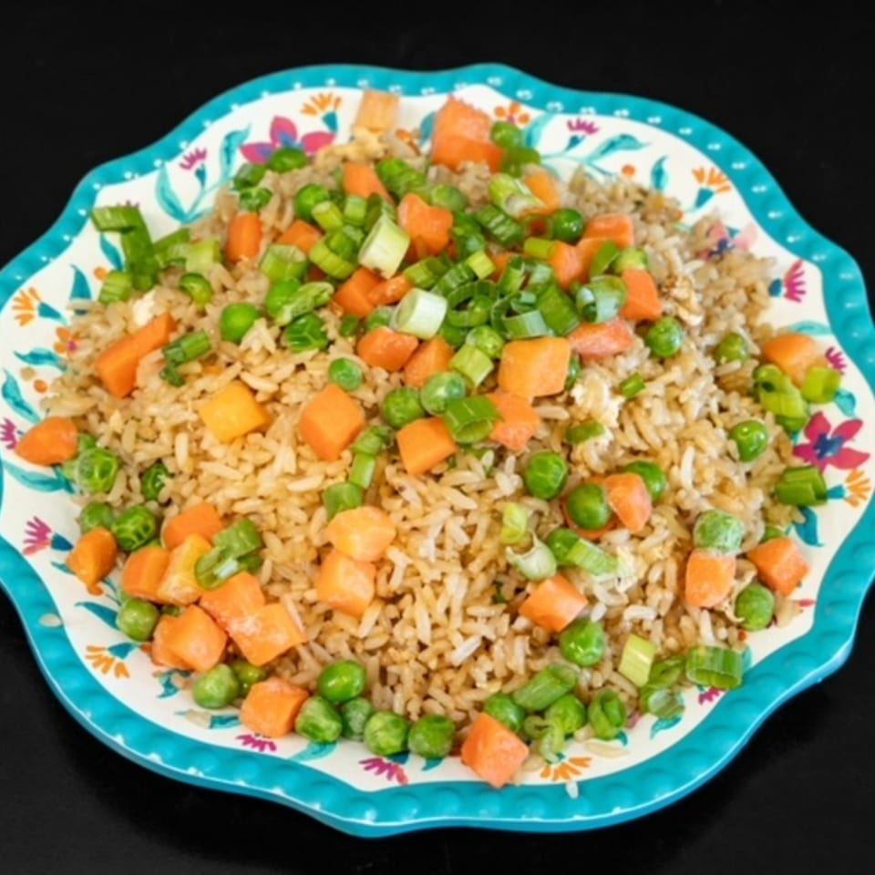 My City Chinese Foods' fried rice with peas, carrots, and green onions on a decorative plate.